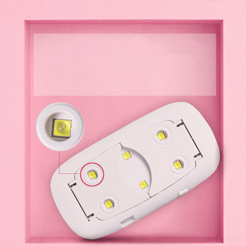 Close-up of white mini UV LED nail lamp beads and portable folding legs for gel polish manicures.