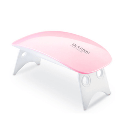 Pink SUNmini portable UV LED nail dryer lamp for gel polish manicure with folding legs on a white background.