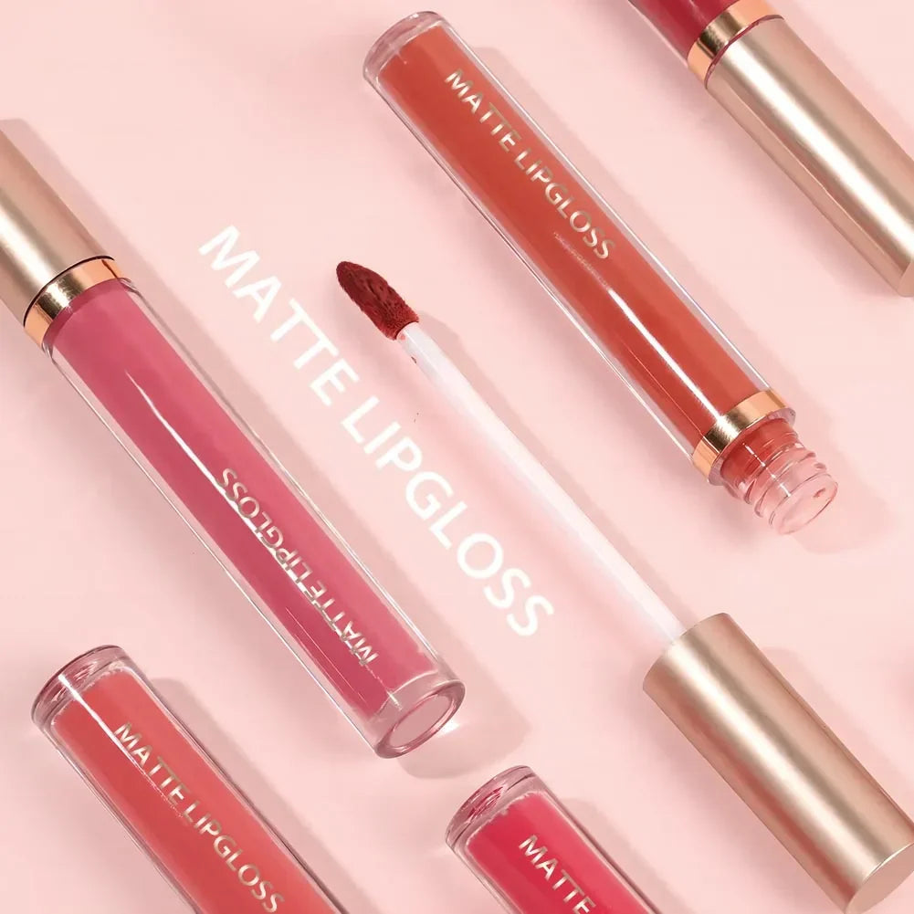 Luxe Glow matte lip gloss kit featuring pink, red, and coral shades with gold caps on a soft pink background.