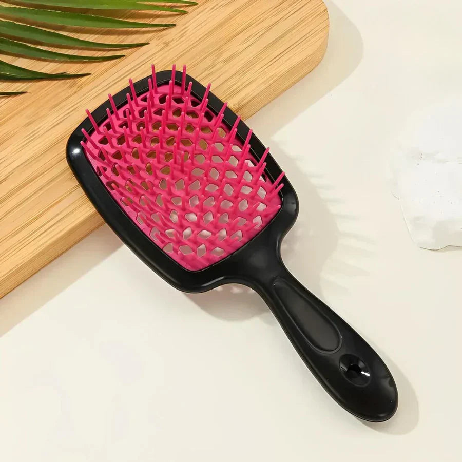 Pink and black Silqé Paddle Hairbrush for wet or dry detangling, featuring a vented design and flexible bristles.
