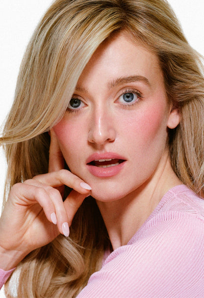Model Sarah Pidgeon wearing Pocket Blush in Teacup, a dewy pink cream blush for a natural, glowy makeup look.